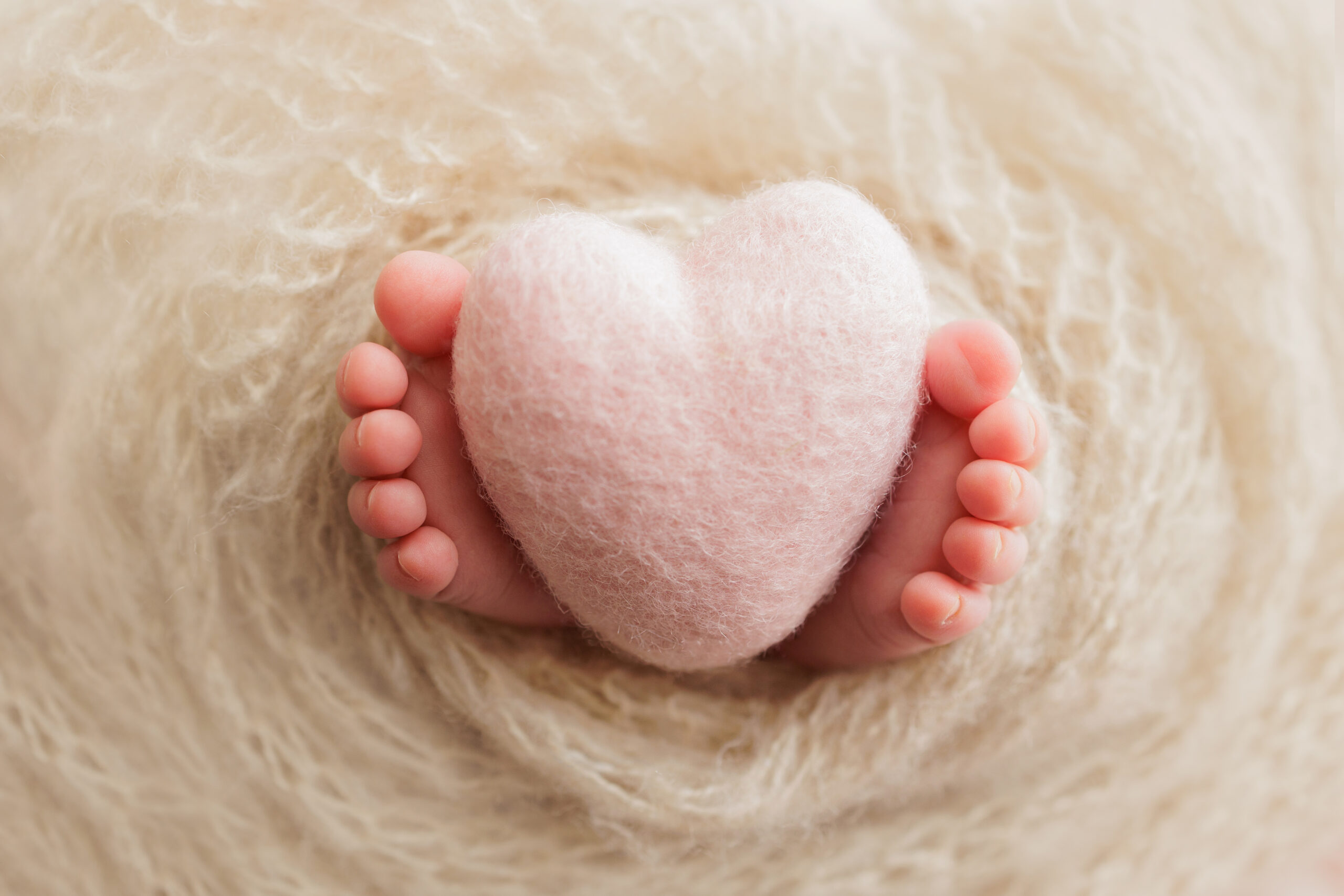 Baby feet holding a felt heart for anyone looking for the best gift ideas for mom