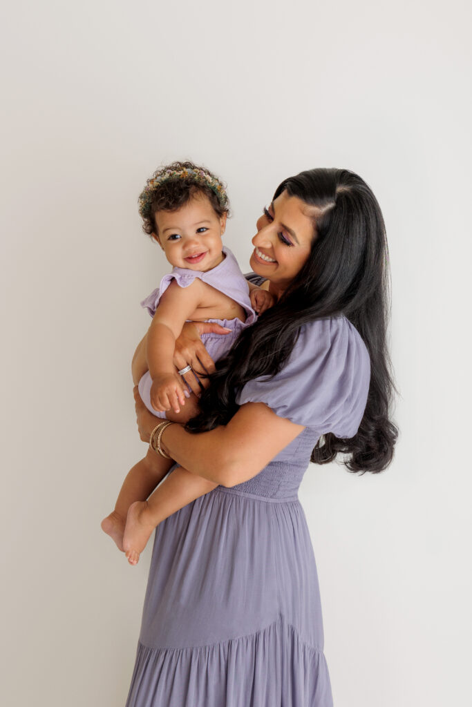 mom and young daughter in a photo studio, white background
